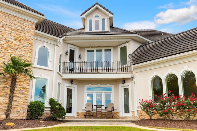 rear view of house featuring french doors and a balcony