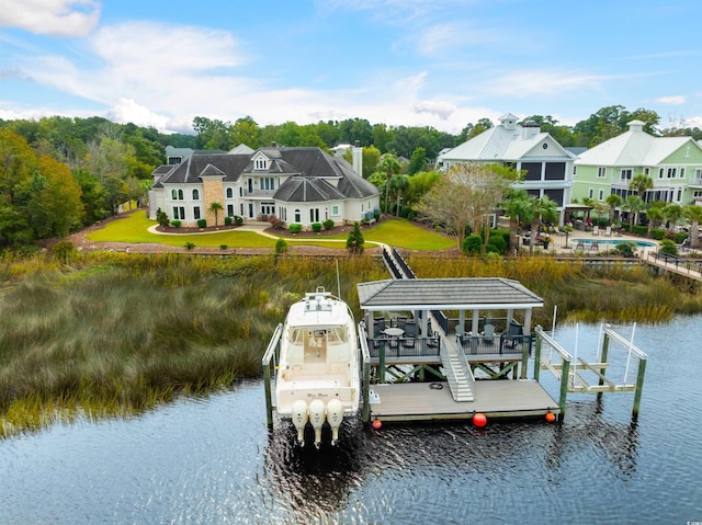 dock area featuring a water view and a swimming pool