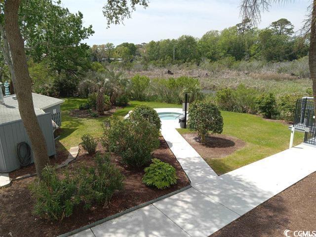 view of home's community with a lawn