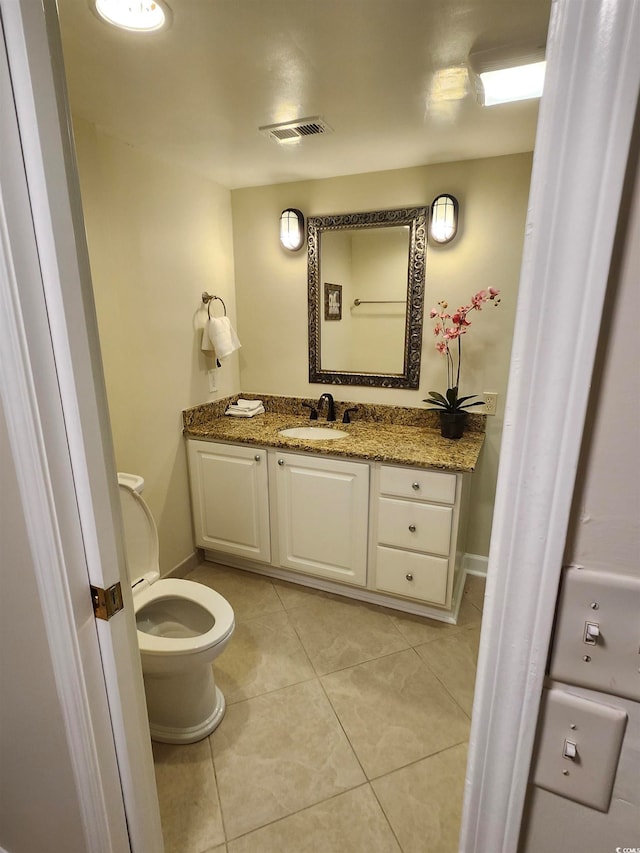 bathroom featuring vanity, toilet, and tile patterned flooring