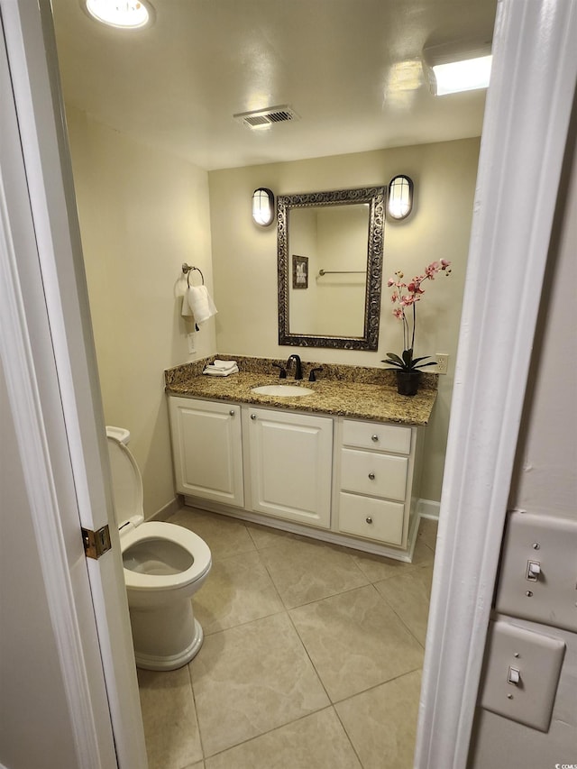 311 69th Ave N Unit 104, Myrtle Beach, SC 29572 - bathroom with toilet, tile patterned floors, visible vents, baseboards, and vanity