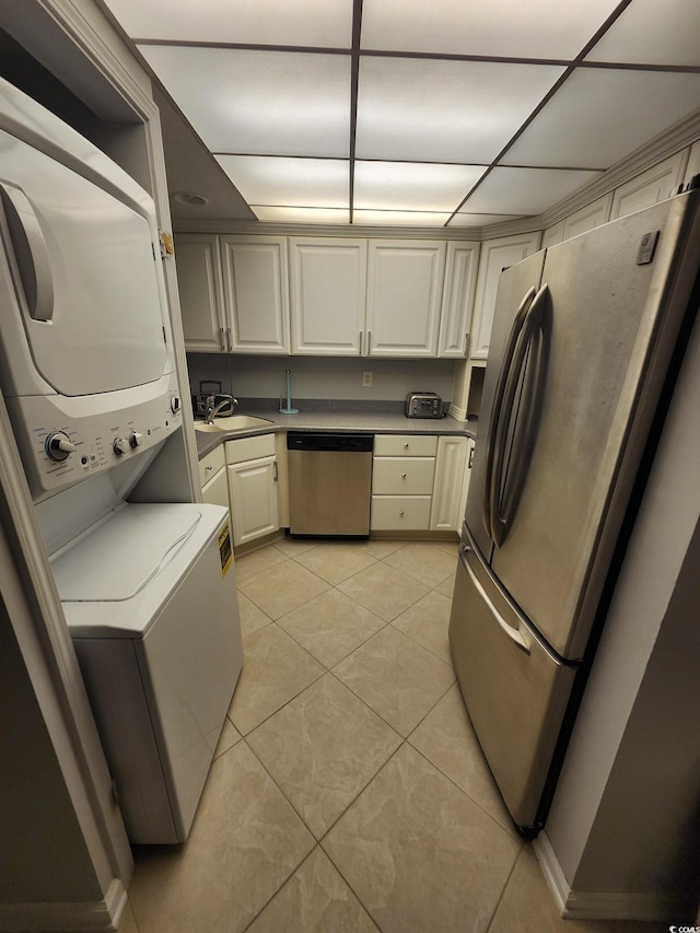 311 69th Ave N Unit 104, Myrtle Beach, SC 29572 - washroom featuring a sink, laundry area, light tile patterned flooring, and stacked washer and dryer
