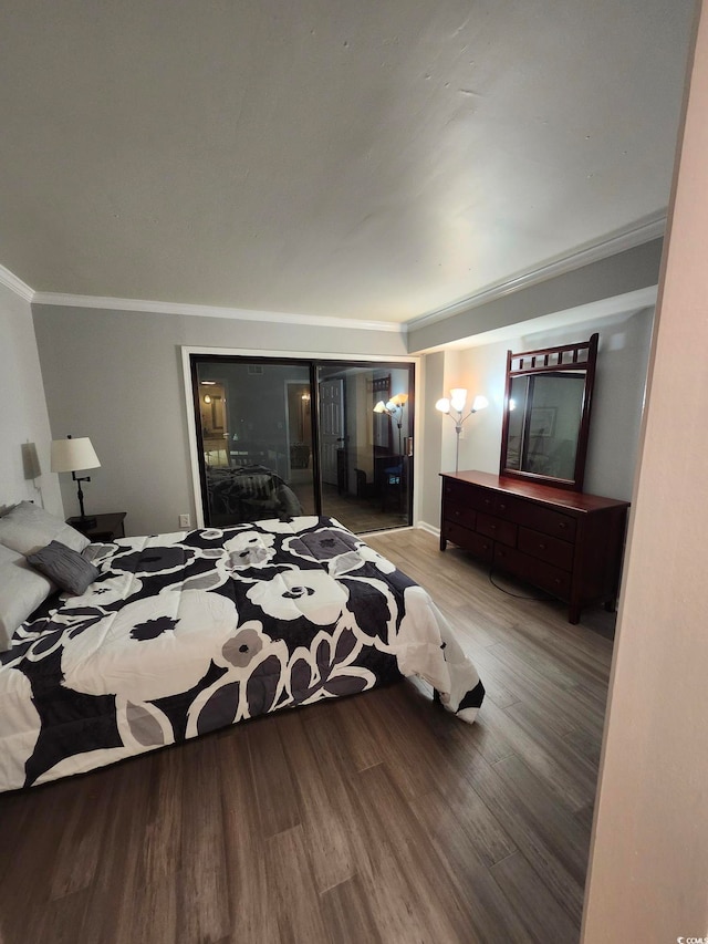 bedroom with light hardwood / wood-style floors and crown molding