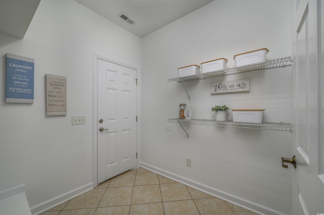 entryway with light tile patterned floors