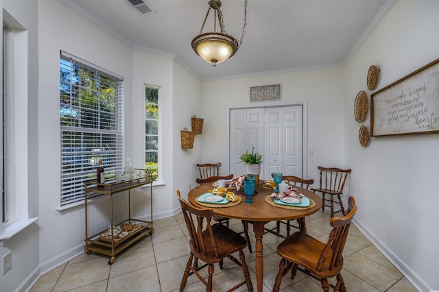 dining room with ornamental molding and light tile patterned floors