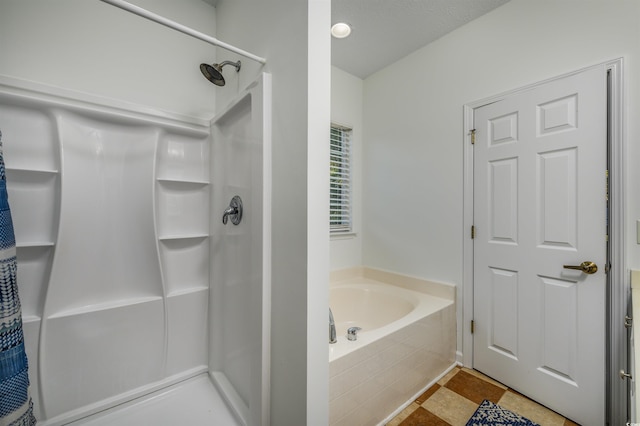 bathroom with shower with separate bathtub