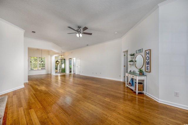 unfurnished living room with crown molding, a textured ceiling, ceiling fan with notable chandelier, and hardwood / wood-style floors