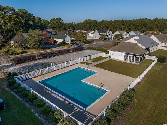 view of pool featuring a patio area and a yard