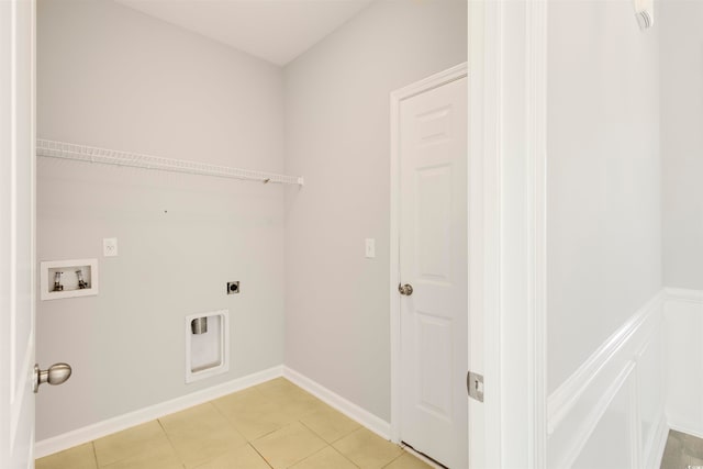 laundry area with light tile patterned flooring, hookup for a washing machine, and hookup for an electric dryer