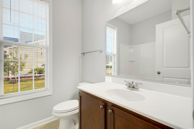 bathroom with plenty of natural light, tile patterned floors, and toilet