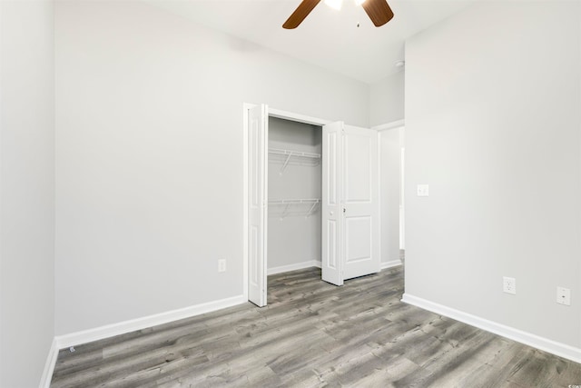 unfurnished bedroom with light hardwood / wood-style floors, ceiling fan, and a closet