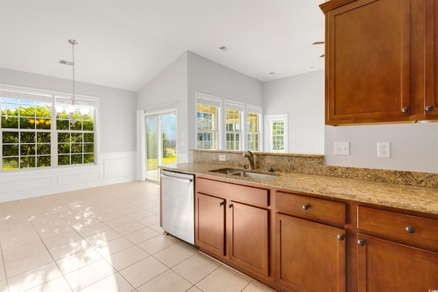 kitchen with stainless steel dishwasher, light tile patterned floors, sink, and light stone counters