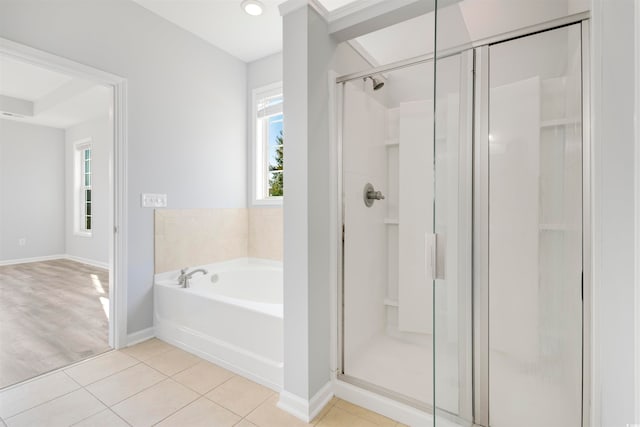 bathroom featuring tile patterned flooring and separate shower and tub