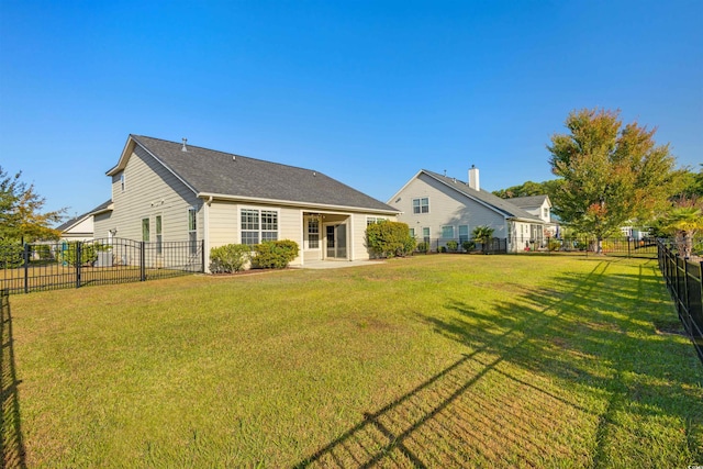 rear view of property with a yard