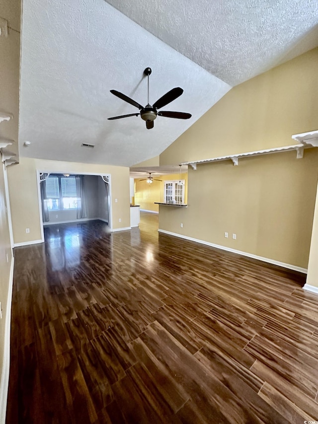 196 Marsh Hawk Dr, Myrtle Beach, SC 29588 - unfurnished living room with a ceiling fan, a textured ceiling, dark wood-type flooring, and lofted ceiling