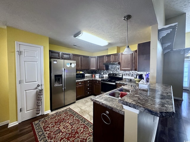 196 Marsh Hawk Dr, Myrtle Beach, SC 29588 - kitchen with stainless steel appliances, a textured ceiling, a peninsula, tasteful backsplash, and dark brown cabinetry