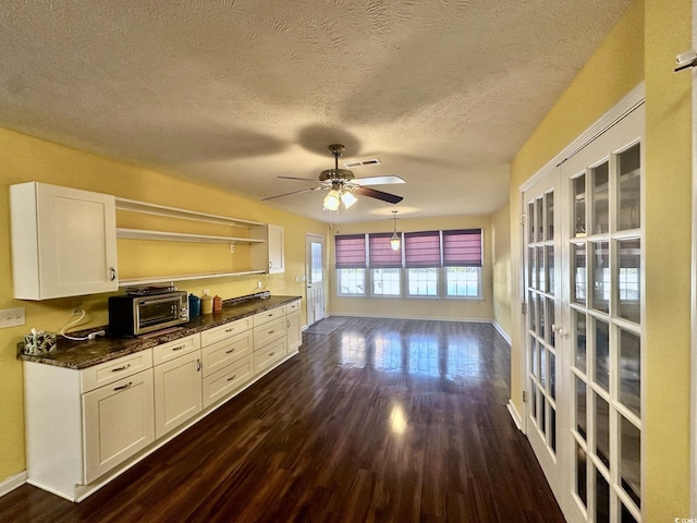 196 Marsh Hawk Dr, Myrtle Beach, SC 29588 - kitchen with dark wood-type flooring, white cabinetry, a textured ceiling, a ceiling fan, and french doors
