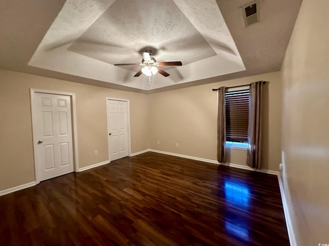 196 Marsh Hawk Dr, Myrtle Beach, SC 29588 - unfurnished bedroom with a tray ceiling, wood finished floors, and a ceiling fan