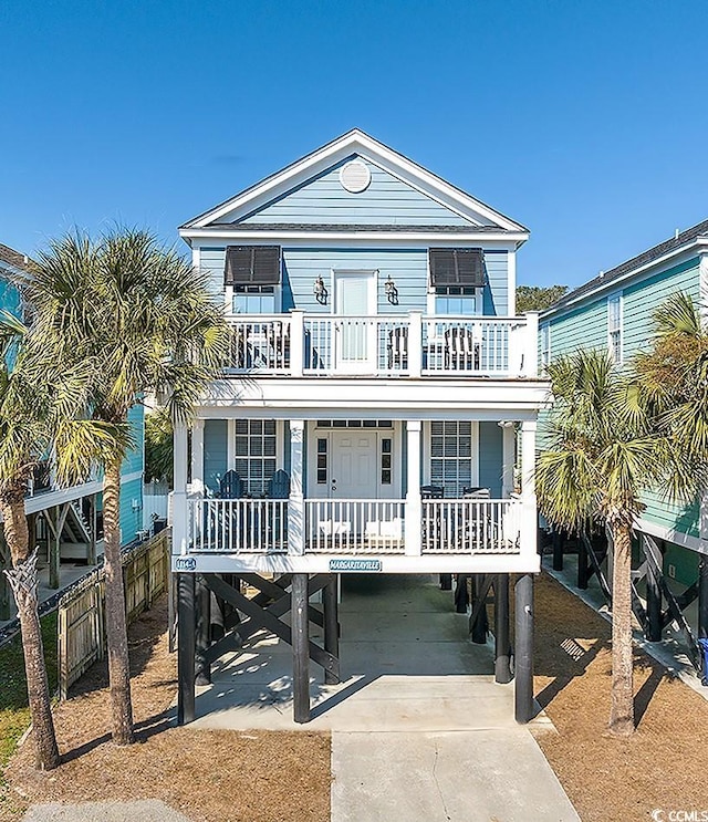 coastal home featuring a carport, a porch, and a balcony