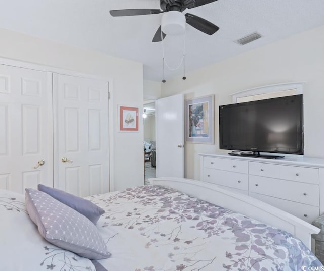 bedroom with ceiling fan and a closet