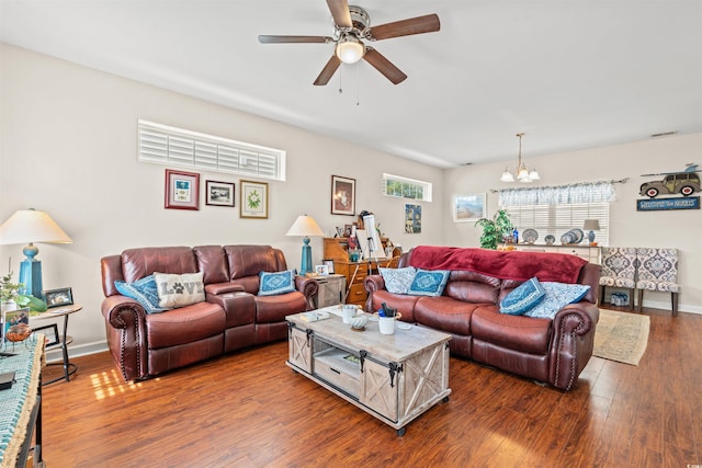 living room with baseboards, wood finished floors, and ceiling fan with notable chandelier