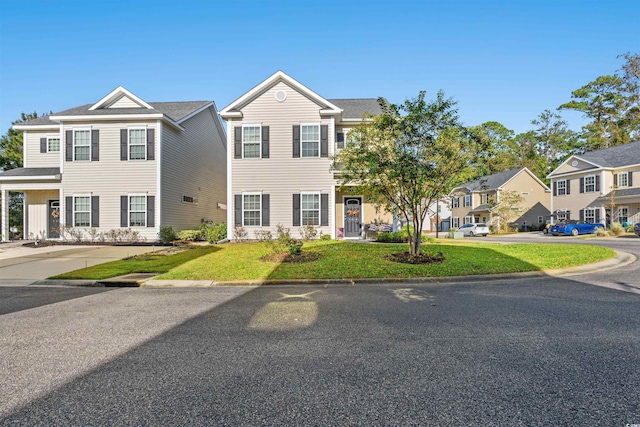 view of front facade with a residential view and a front lawn