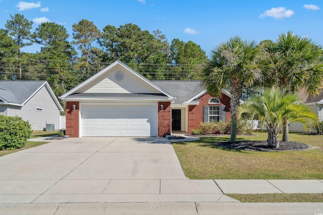 view of front of home featuring a front lawn and a garage