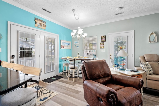 6001-7038 S Kings Hwy, Myrtle Beach, SC 29575 - living room with a chandelier, wood finished floors, crown molding, and a textured ceiling