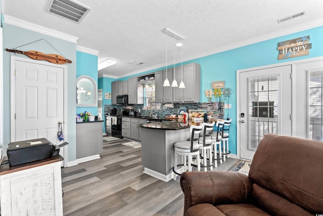 6001-7038 S Kings Hwy, Myrtle Beach, SC 29575 - kitchen featuring gray cabinets, black appliances, dark countertops, wood finished floors, and ornamental molding