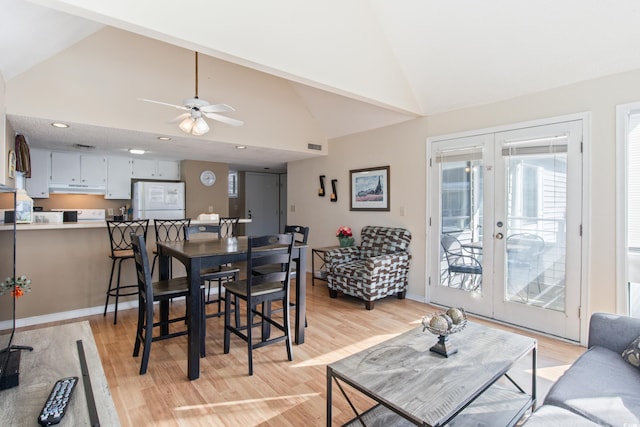 dining area with french doors, light wood-type flooring, vaulted ceiling, and ceiling fan