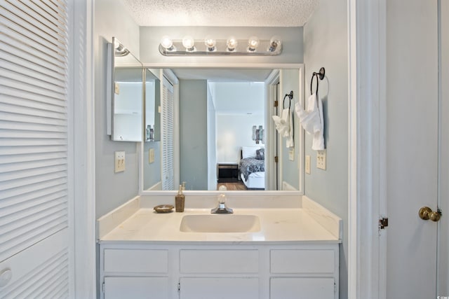 bathroom with a textured ceiling and vanity