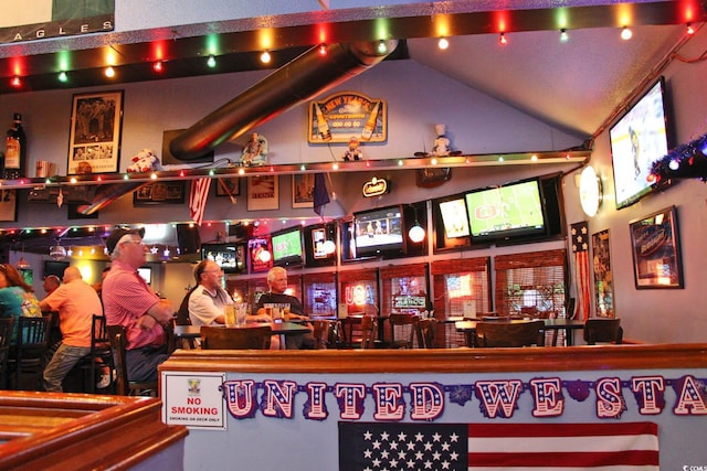 bar featuring vaulted ceiling