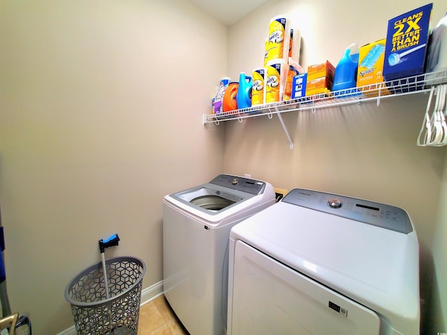 washroom with washer and dryer and light tile patterned floors