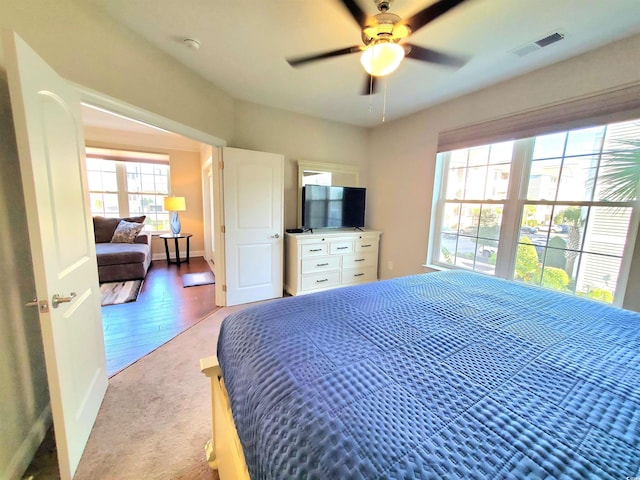 bedroom with light hardwood / wood-style flooring and ceiling fan