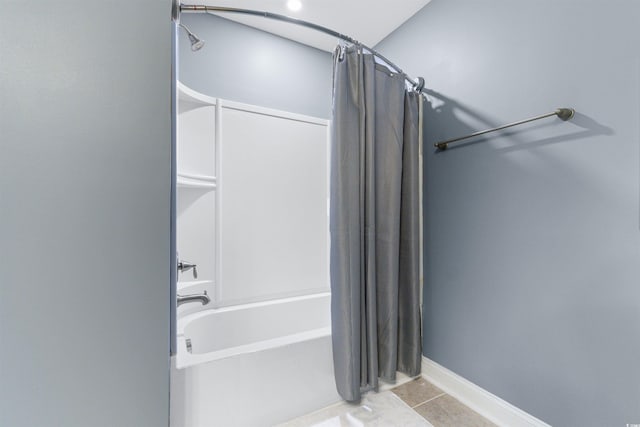 bathroom featuring tile patterned floors and shower / bath combo with shower curtain