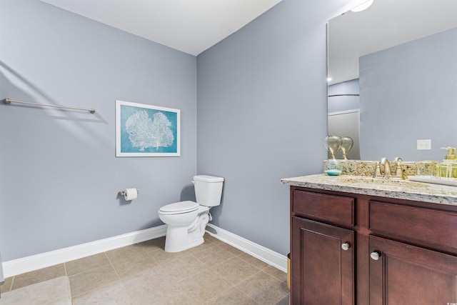 bathroom with vanity, toilet, and tile patterned floors