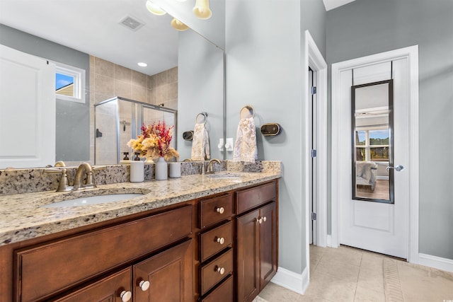 bathroom featuring vanity, tile patterned flooring, and a shower with door