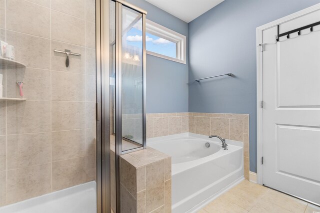 bathroom featuring shower with separate bathtub and tile patterned floors