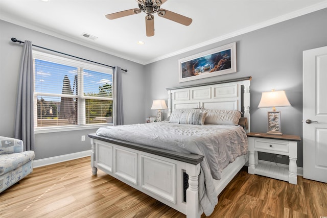 bedroom featuring crown molding, light hardwood / wood-style flooring, and ceiling fan