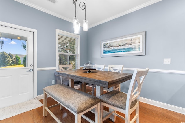 dining area featuring ornamental molding and hardwood / wood-style floors