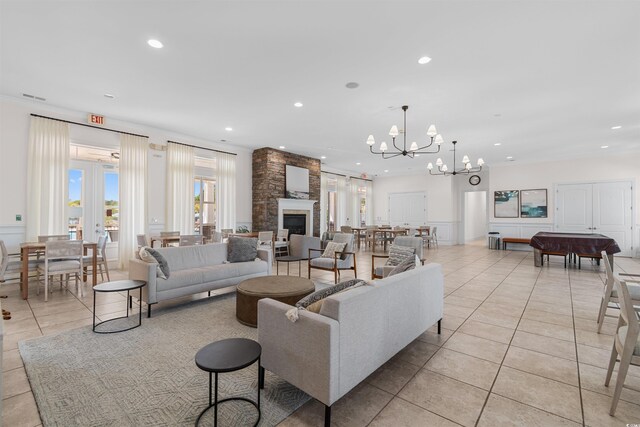 tiled living room with an inviting chandelier and a large fireplace