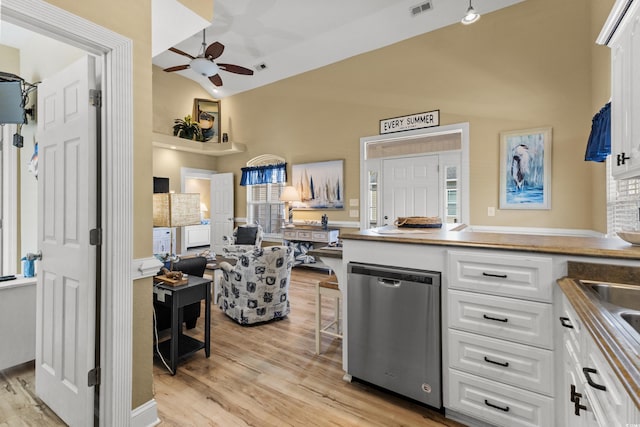 kitchen with ceiling fan, white cabinets, stainless steel dishwasher, and light hardwood / wood-style floors