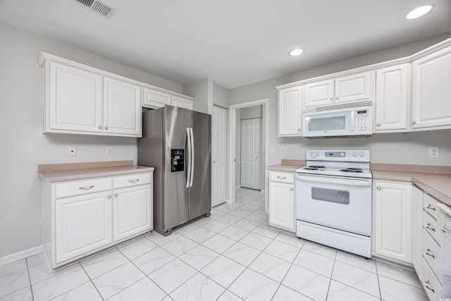 kitchen with white cabinetry and white appliances