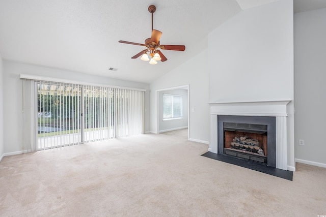 unfurnished living room with light carpet, high vaulted ceiling, and ceiling fan