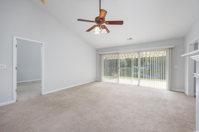 spare room featuring light carpet, lofted ceiling, and ceiling fan