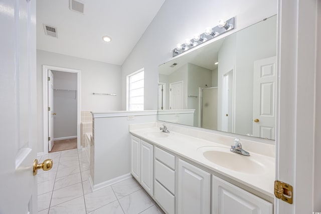 bathroom with vanity, vaulted ceiling, and a shower with shower door