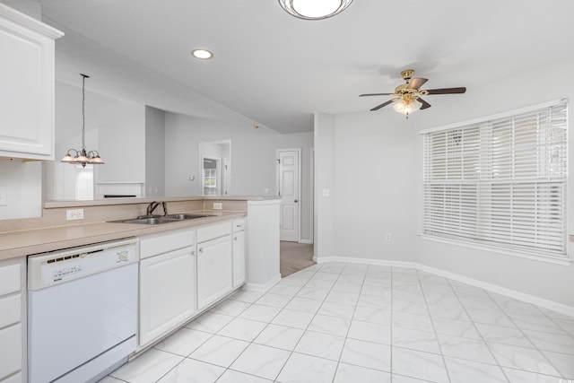 kitchen with sink, dishwasher, ceiling fan with notable chandelier, hanging light fixtures, and white cabinetry