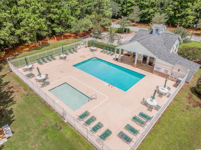 view of pool featuring a patio and a lawn