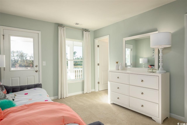 carpeted bedroom featuring multiple windows