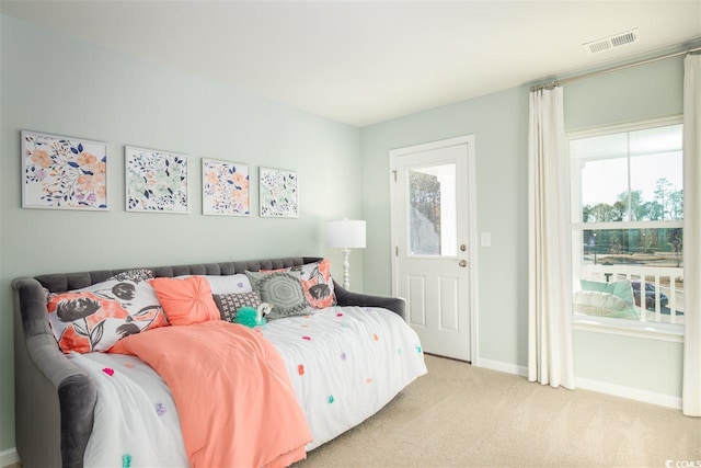 bedroom featuring light carpet